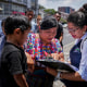 People in Guatemala check on a list.
