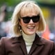 E. Jean Carroll smiles as she arrives at Manhattan federal court