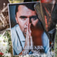 Pictures of Charlie Kirk next to bouquets of flowers on the grass