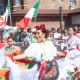 Women dance in a parade crowd