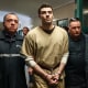 Luigi Mangione, accused of the murder of United Healthcare CEO Brian Thompson, is escorted by police as he arrives at court in New York City on September 16, 2025. 
