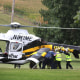 An officer is loaded into a helicopter