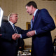 U.S. President Donald Trump shakes hands with James Comey, former director of the FBI in the White House.