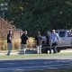 Law enforcement officials next to the vehicle used to ram the exterior of the Church of Jesus Christ of Latter-day Saints in Grand Blanc Township, Mich.