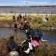 Migrants, predominantly from Venezuela, cross the Rio Grande 