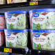 A view of rows of mint chip and strawberry ice cream containers in a store freezer