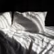 Bed with white bed linen. Empty bed. Bedroom.