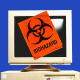 Photo illustration ofa biohazard sticker pasted on top of a vintage computer 