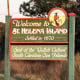 The sign for Saint Helena Island on the side of a two way road