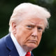 Donald Trump walks and gives a thumbs up