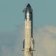 SpaceX's mega rocket Starship blasts off into the sky past clouds
