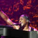 D'Angelo performing while playing the piano.
