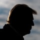 President Donald Trump against a cloudy sky.