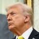 Donald Trump, behind him is a painted portrait of Ronald Reagan
