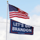 A "Let's go Brandon" flag flies below the American flag.