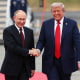 Donald Trump and Vladimir Putin shaking hands.