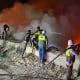 Firefighters battle blazes following a series of Israeli strikes in Ansar, southern Lebanon, on Oct. 16, 2025.