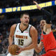 Nikola Jokic of the Denver Nuggets drives against Nikola Vucevic of the Chicago Bulls on Oct. 14, 2025.