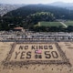 Protesters form a human banner during the "No Kings" national day of protest on Ocean Beach in San Francisco on Oct. 18, 2025.