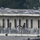 People on a balcony of a building with what appears to be Starlink satellite dishes