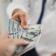 Paying medical bills with cash.
