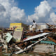 A man looks for salvageable items in the aftermath of Hurricane Melissa in Black River, Jamaica, Thursday, Oct. 30, 2025.