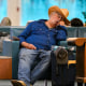 Travellers sleep on chairs during flight delays at Orlando International Airport in Florida on Oct. 30, 2025, after the Federal Aviation Administration (FAA) said the airport had no certified air-traffic controllers in its tower, forcing arrivals to be halted or severely delayed.