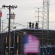 Members of law enforcement keep an eye on demonstrators as they stand on the roof of the immigration processing and detention center on Oct. 17, 2025 in Broadview, Ill.