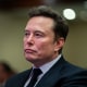 Elon Musk listens as President Donald Trump speaks during a meeting with House Republicans at the Hyatt Regency hotel in Washington, D.C. on November 13, 2024.