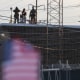 People on the roof of the immigration processing and detention center watch demonstrators in Broadview, I.L.