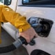 A customer refuels his car at a gas station.