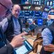Traders work on the floor.