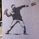 Banksy-style posters depicting a man throwing a sandwich in Washington, D.C.