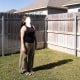 Jane Doe, face obscured by sunlight, in her backyard.