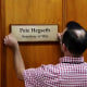 A worker places a plaque that reads "Pete Hegseth - Secretary of War" in Washington on Sept. 5, 2025.  
