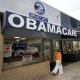 An Obamacare sign is displayed outside an insurance agency