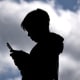 A 14-year-old boy looks at social media on his phone in Gosford, Australia. 