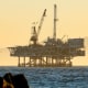 A person fishes with offshore oil and gas platform in California. 