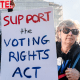 Protestors hold signs outside of the Supreme Court building, one says "Support the voting rights act" and another says "Protect our vote"