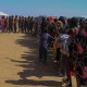 Families line up to receive humanitarian aid at the Al-Afad camp for displaced people on Nov. 25