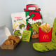 McDonald's Chicken Nuggets, a green packet of Grinch Salt, french fries, green Grinch socks displayed on a table