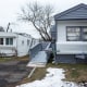 A '"for sale" sign is seen in a window of a mobile home