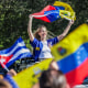 People wave Venezuelan flags outside