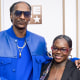 Snoop Dogg, left, places his arm around Cori Broadus' shoulder, right