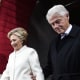 Hillary Clinton and Bill Clinton walk out of a building together