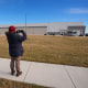 A man takes photos of a warehouse as federal officials tour the facility to consider repurposing it as an ICE detention facility Thursday, Jan. 15, 2026, in Belton, Mo. 