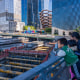 A woman and two kids overlook a a construction site in Manhattan.