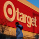 A Target retail store is seen while a woman walks past it. 