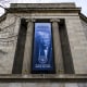 Image: A a new banner featuring an image of President Donald Trump is displayed on the facade of the U.S. Department of Justice