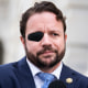 Dan Crenshaw appears outside the U.S. Capitol while wearing a black eyepatch on his right eye.